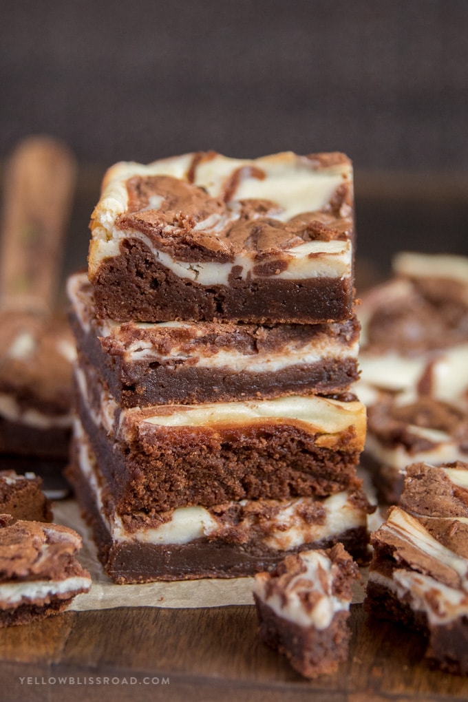 Cream Cheese Brownies stacked on top of each other.