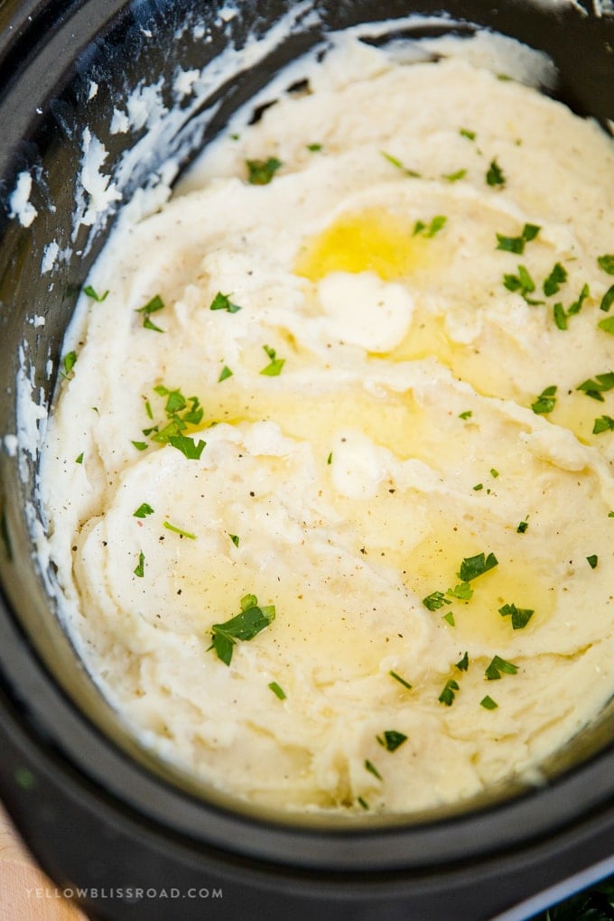 Crock Pot Mashed Potatoes with melted butter and parsley.