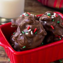 A container of Crockpot candies with a glass of milk.