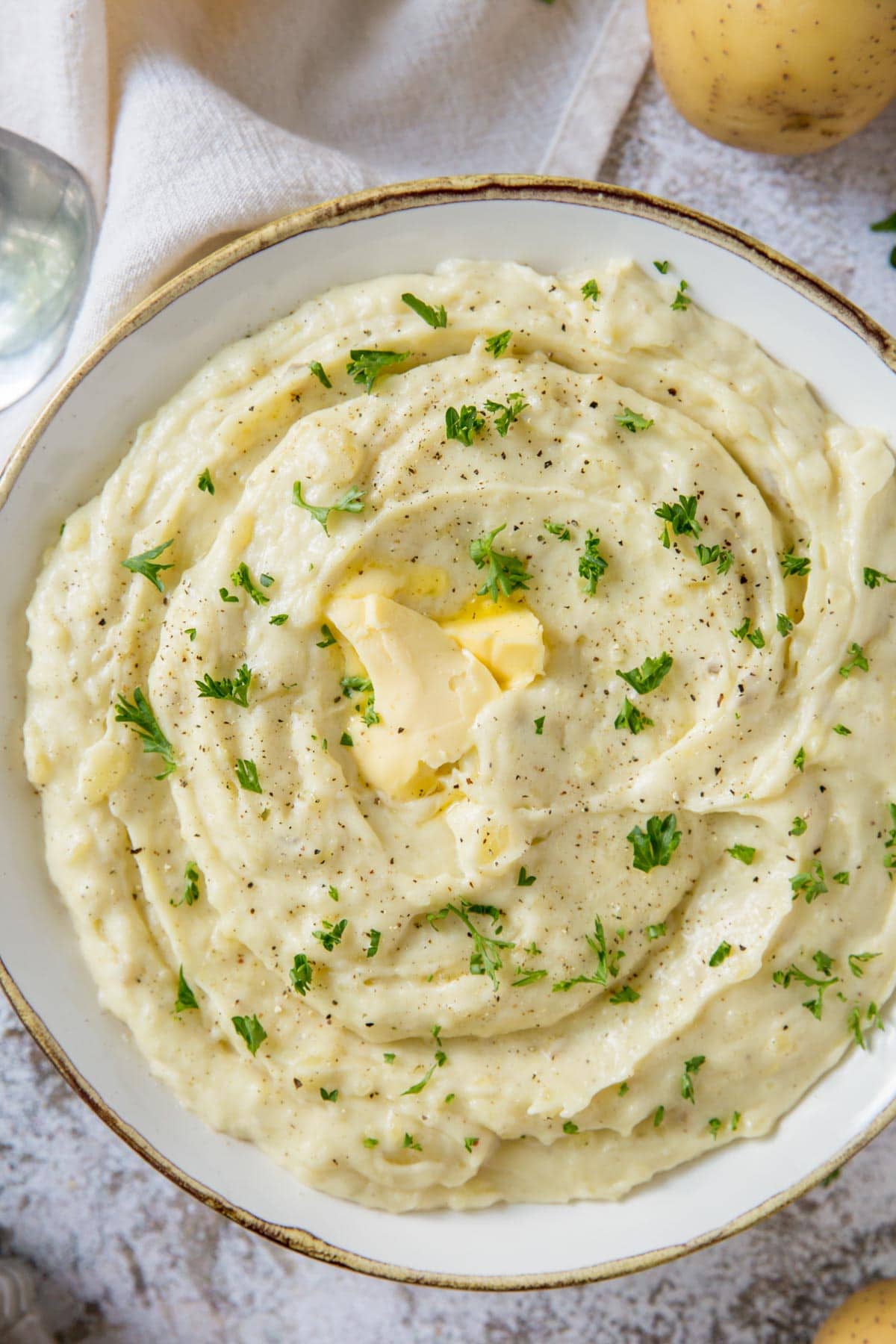 mashed potatoes in a white dish with butter