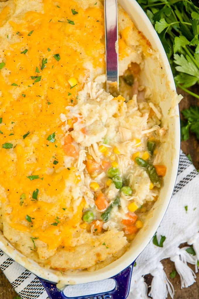 Turkey Shepherd's Pie with potatoes, turkey, vegetables and gravy in a casserole dish with a stainless steel spoon.