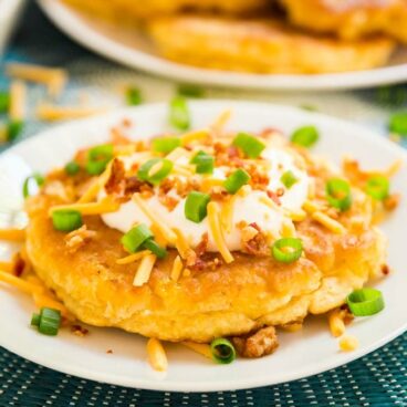 A loaded corn fritter on a plate