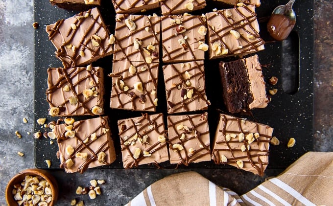 Overhead image of brownies with nutella frosting and hazelnuts.