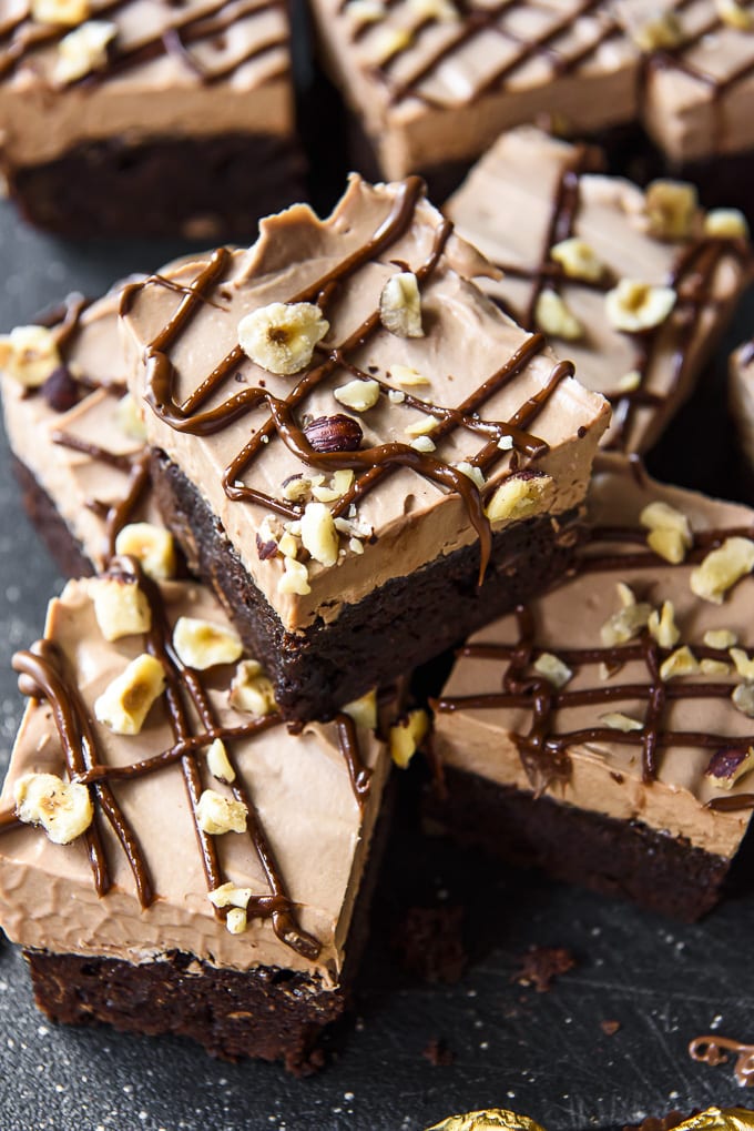 Chocolate brownies with nutella frosting and drizzle, hazelnuts.