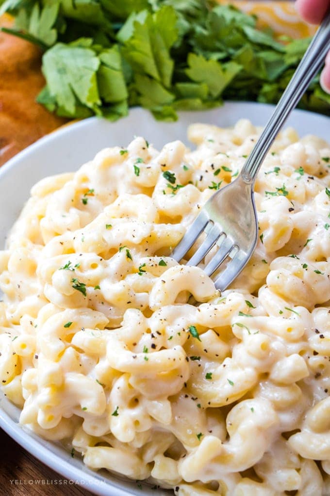 mac and cheese in a large bowl with a fork