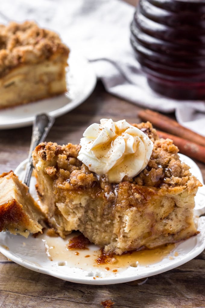 A big slice of cinnamon baked french toast with a bit taken out of it.