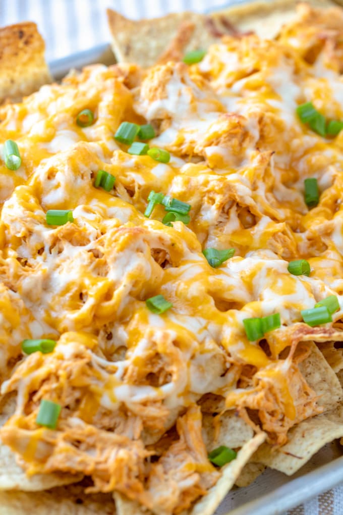 A close up of a large pan of buffalo chicken nachos.