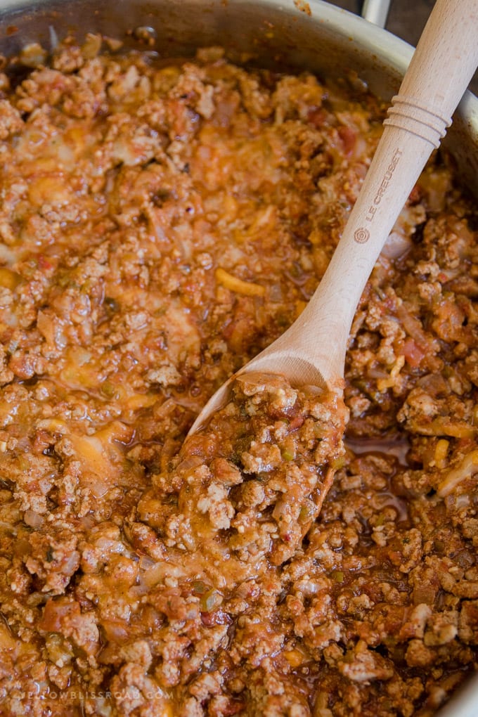 Ground Turkey Taco meat in a pot with a wooden spoon.