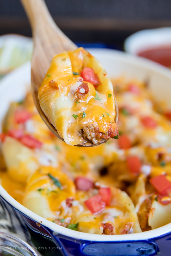 A Turkey Taco Stuffed Shell on a wooden spoon.