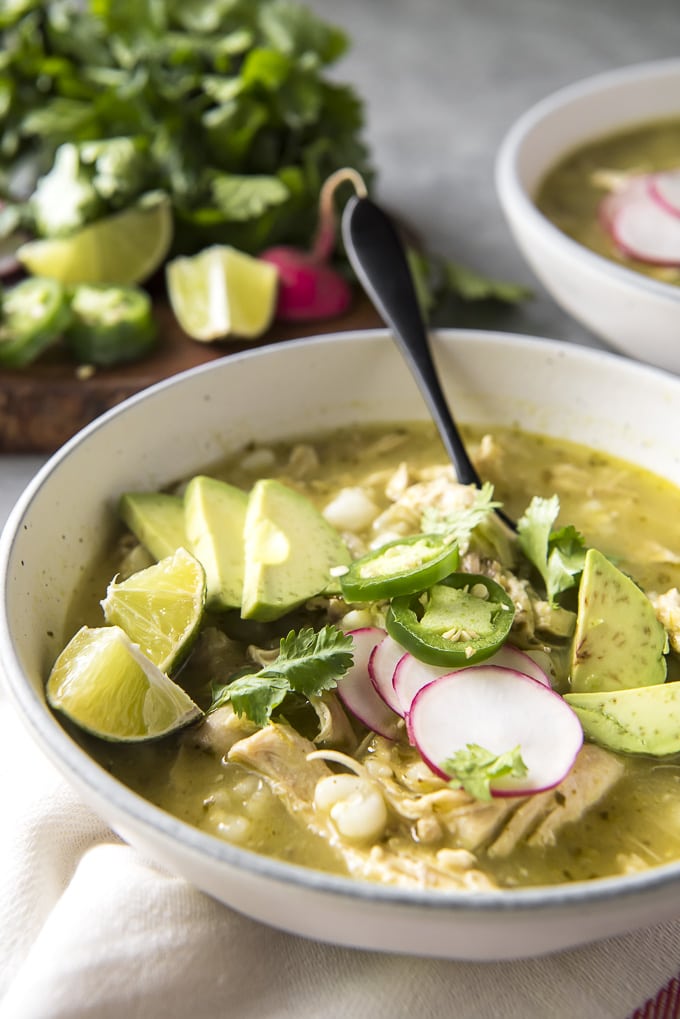 Bowl of Pozole Verde with a spoon in it