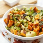 This delicious combination of roasted Brussels sprouts, sweet potatoes, and grains topped with a creamy apple vinaigrette is the perfect Thanksgiving Salad