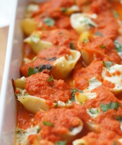 close up of stuffed shells in a pan after baking
