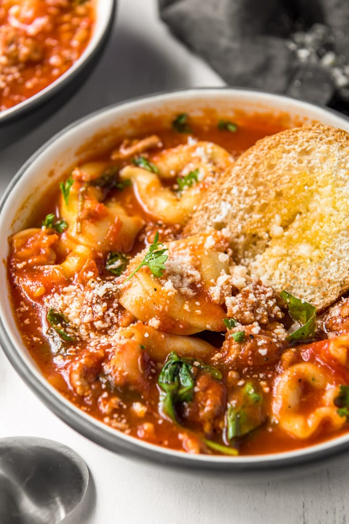 Tortellini Soup with tomato broth, fresh parsley and a toasted crostini