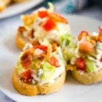 Crostini pieces with wedge salad dip on a plate.