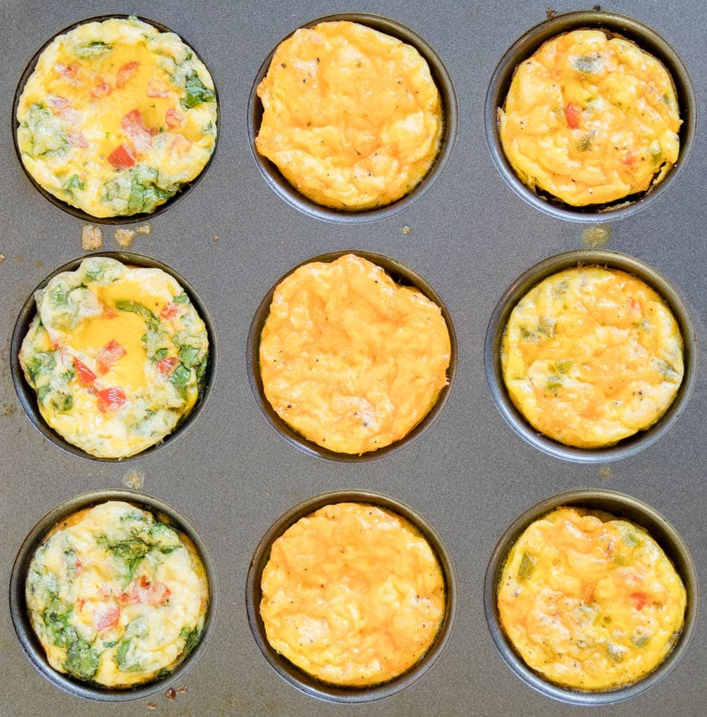 Egg Muffins are an easy breakfast option that are full of protein and easy to customize. Baked Egg Muffin Cups are a great grab and go breakfast or snack. A photo of 9 egg muffins in a muffin pan.