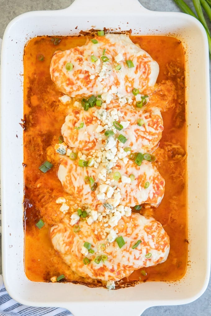 Baked Buffalo Chicken Breasts are tender and juicy, smothered in spicy buffalo sauce and melted cheese. A simple, 3-ingredient dinner recipe.