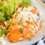 A plate of Buffalo chicken with salad