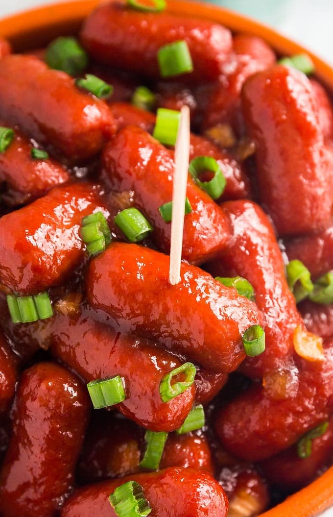 A close up image of crockpot BBQ Little Smokies with a tooth pick