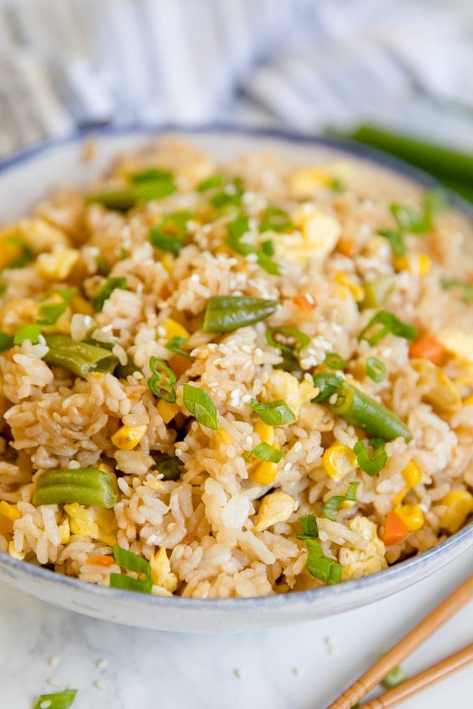 A bowl of egg fried rice with veggies
