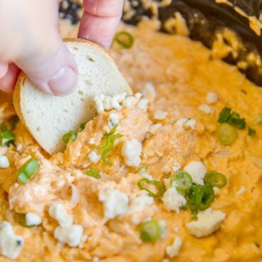 Buffalo chicken dip with a piece of bread