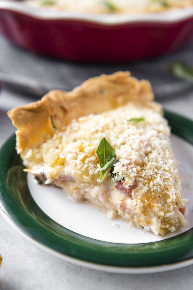 A close up of a slice of tomato pie.