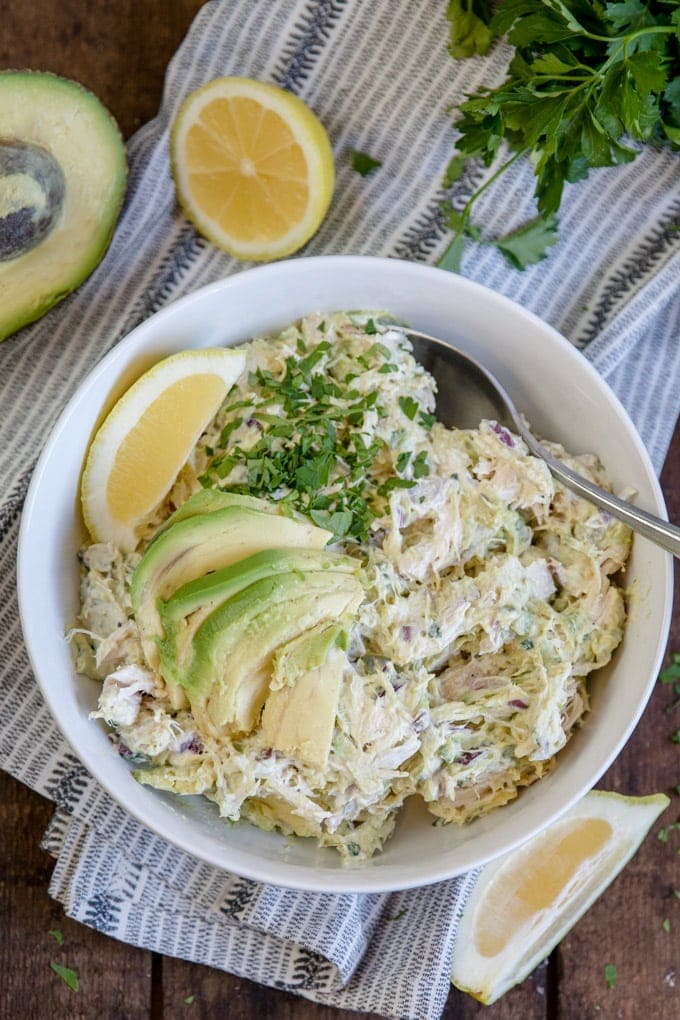Avocado Chicken salad in a large white bowl with sliced avocado on top