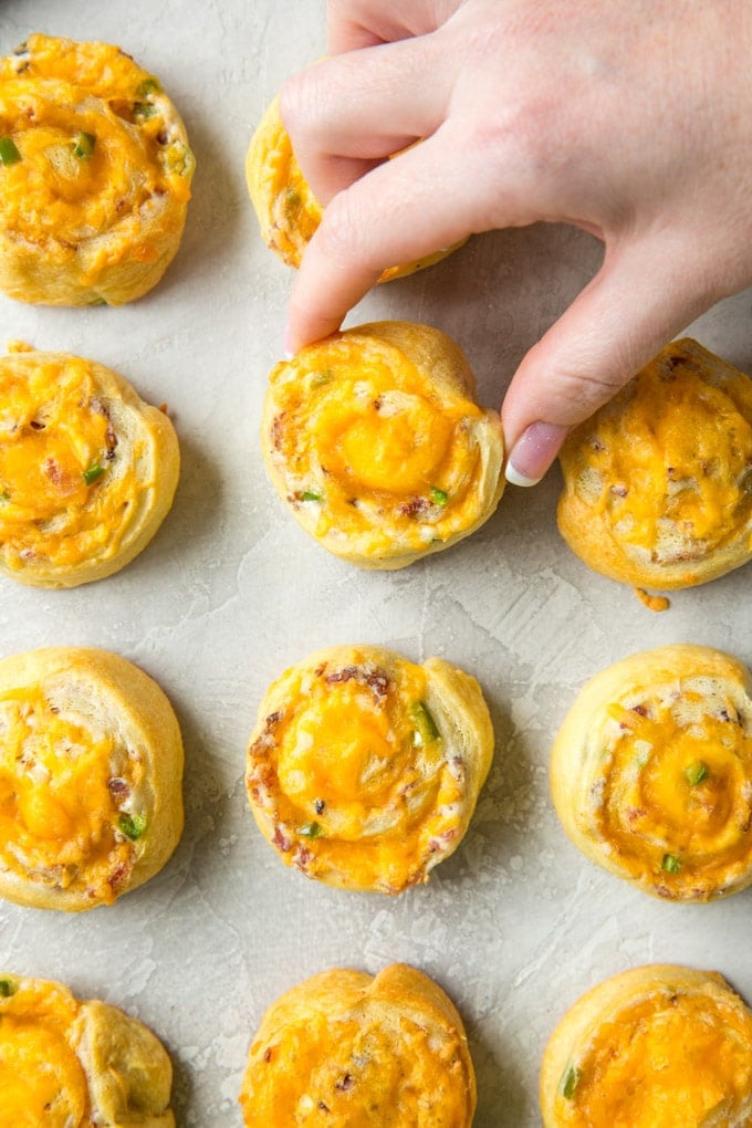 Jalapeno Popper Pinwheels with a hand reaching in