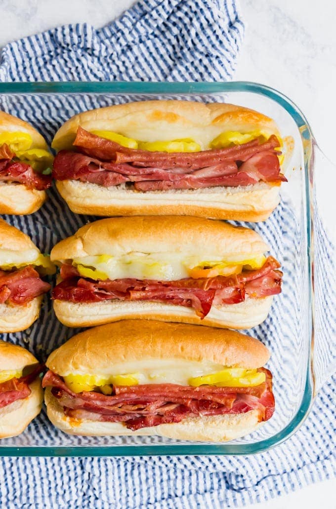 An overhead image of sub sandwiches in a pan