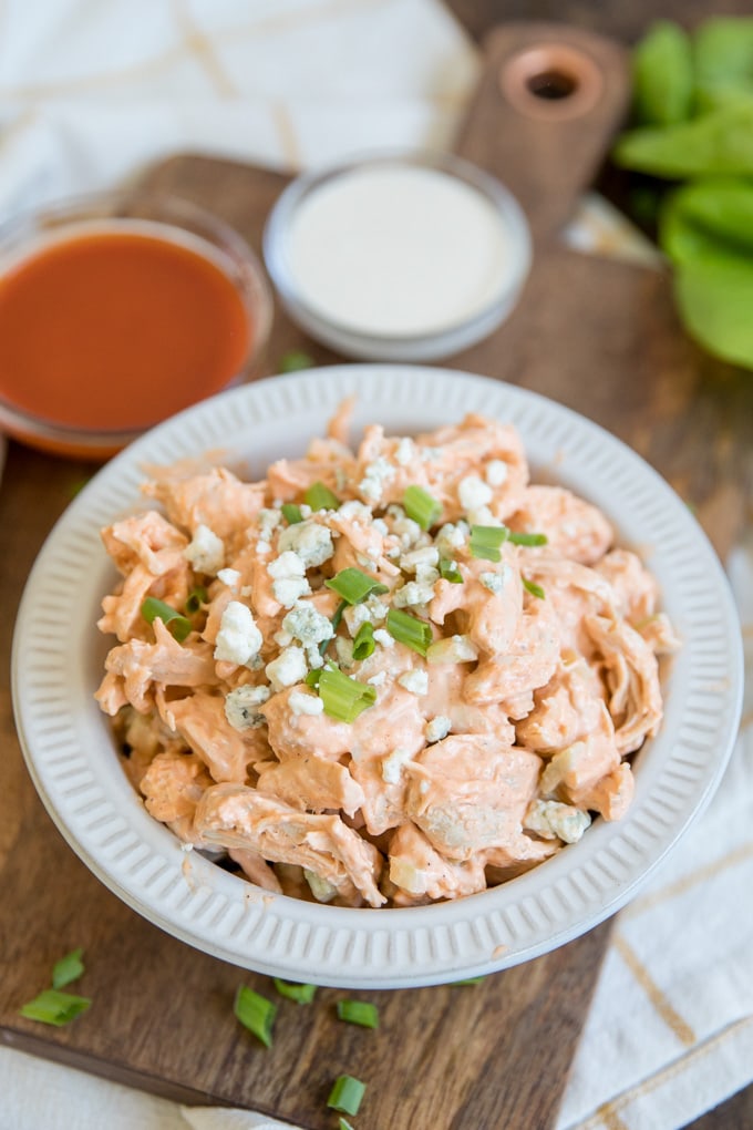 A bowl of chicken salad with ranch and buffalo sauce