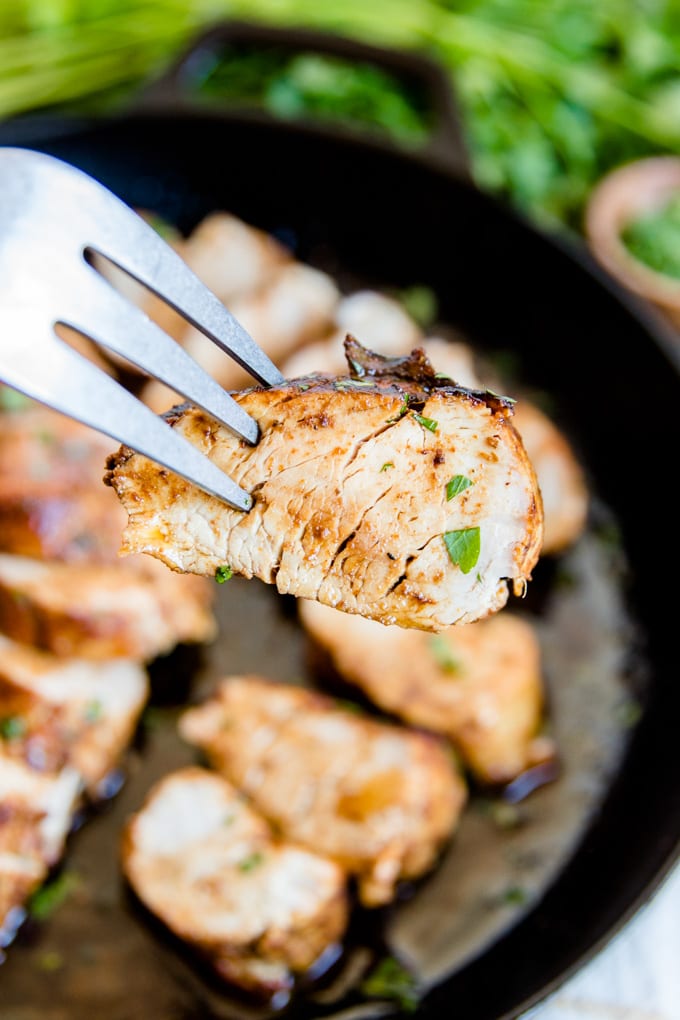 This easy Cajun Pork Tenderloin is the perfect main attraction for any dinner and a simple 2-step process guarantees a tender, juicy bite every time. Close up of a slice of pork tenderloin.