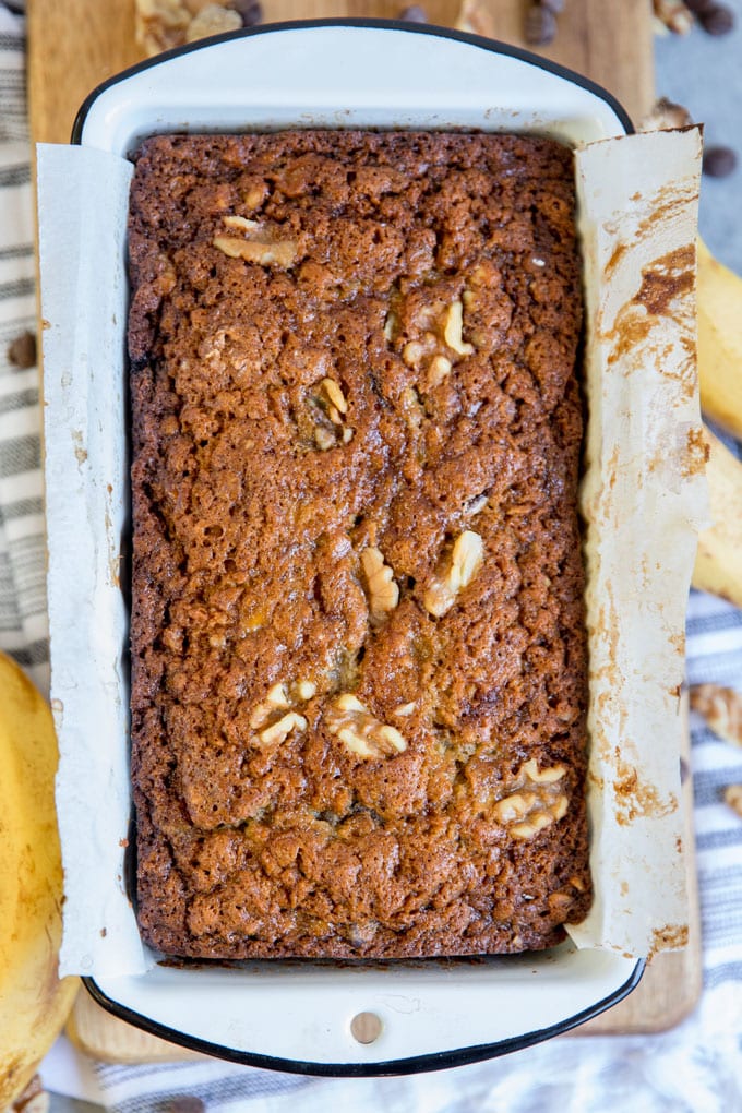 A loaf of just baked chunky monkey banana bread in the pan.