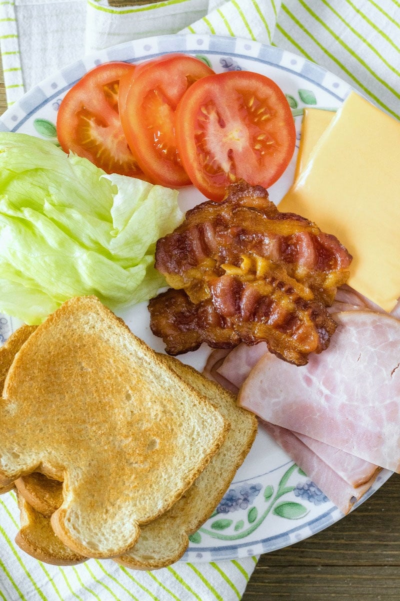 ingredients to make a club sandwich spread out on a plate