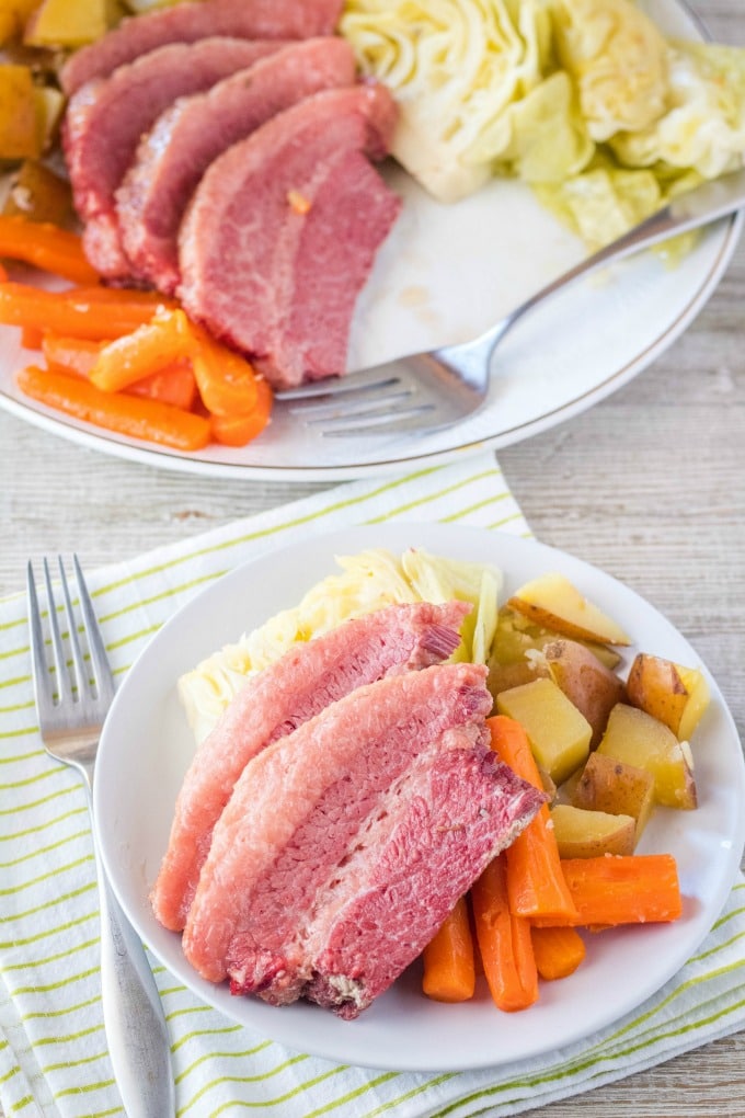 portion of corned beef and cabbage, carrots, and potatoes on a plate