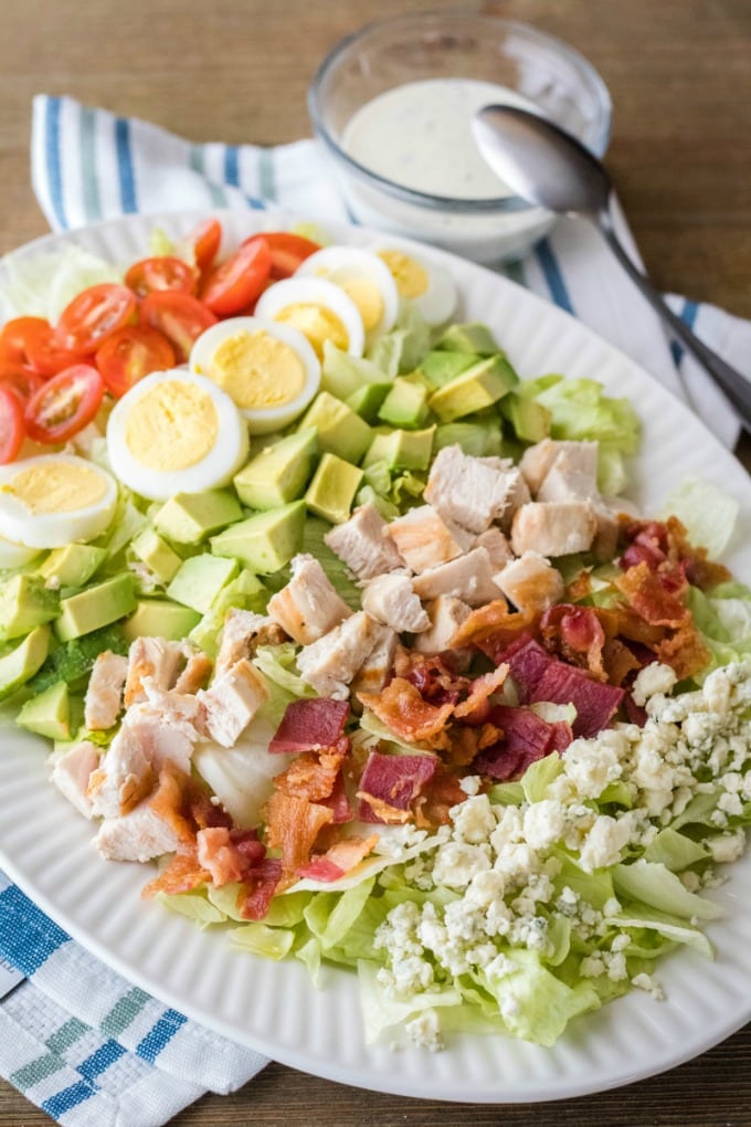 This easy to make Classic Cobb Salad is loaded with all the best salad toppings. Just add your dressing of choice and you have a fantastic lunch or lighter dinner option! classic cobb salad with ranch dressing on the side