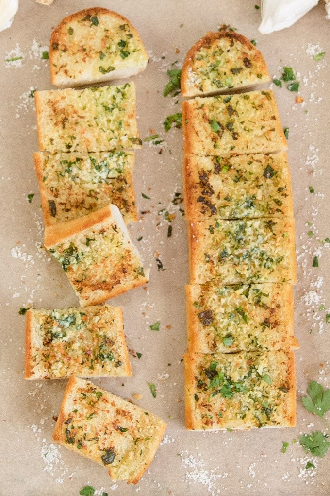 An overhead image with 2 sliced loaves of garlic bread.