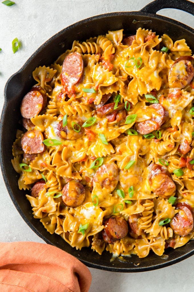 sausage, butterfly pasta, cheese sauce and tomatoes