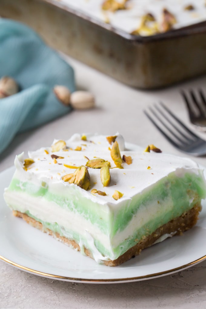 A close up of pistachio pudding cake that shows the layers.