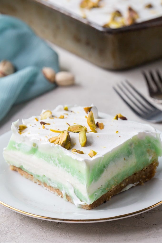 A close up of pistachio pudding cake that shows the layers.