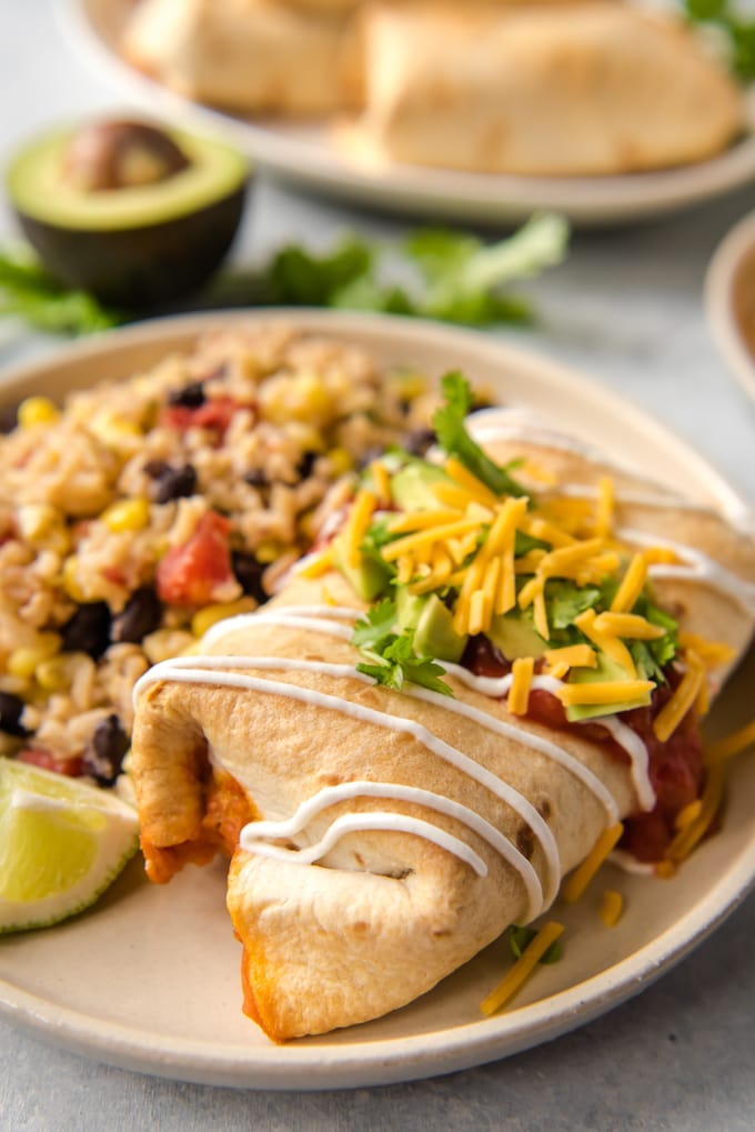 Baked chimichanga on a plate with rice