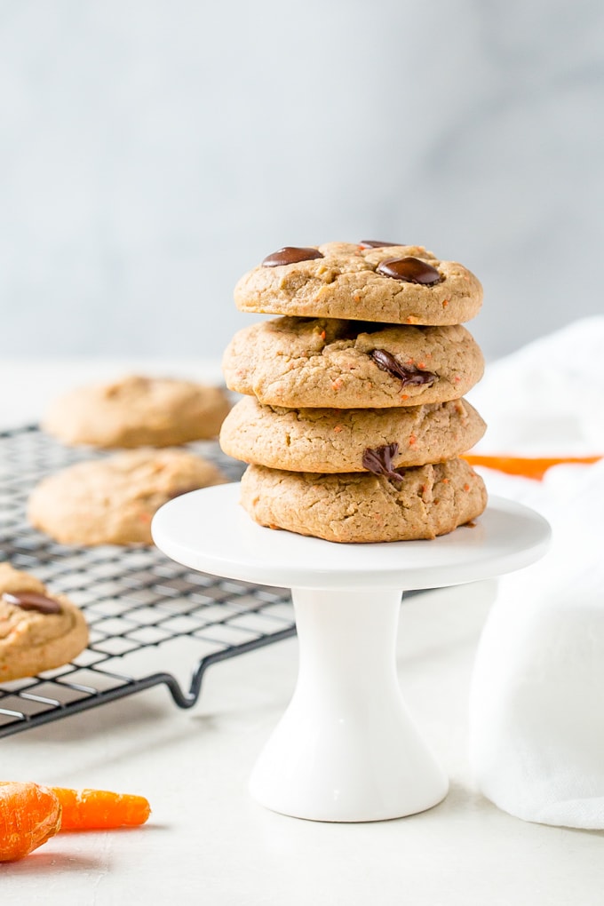 A stack of carrot cake mix cookies on a white stand.