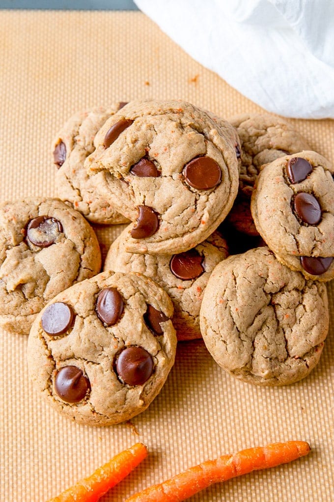 Carrot Cake Mix Cookies in a pile with some carrots off to the side