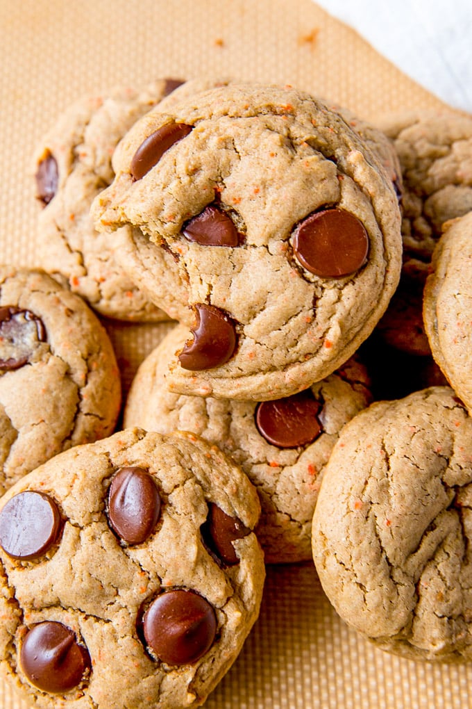 Carrot Cake Cookies in a pile with a bite taken out of one cookie