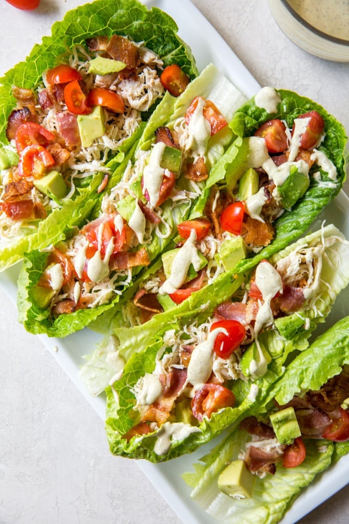 romaine lettuce cups with chicken, bacon, tomatoes and dressing.