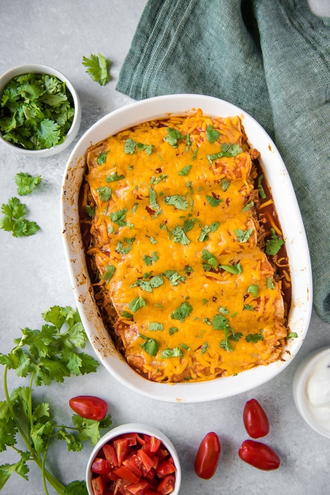 An overhead shot of a pan of chicken enchiladas