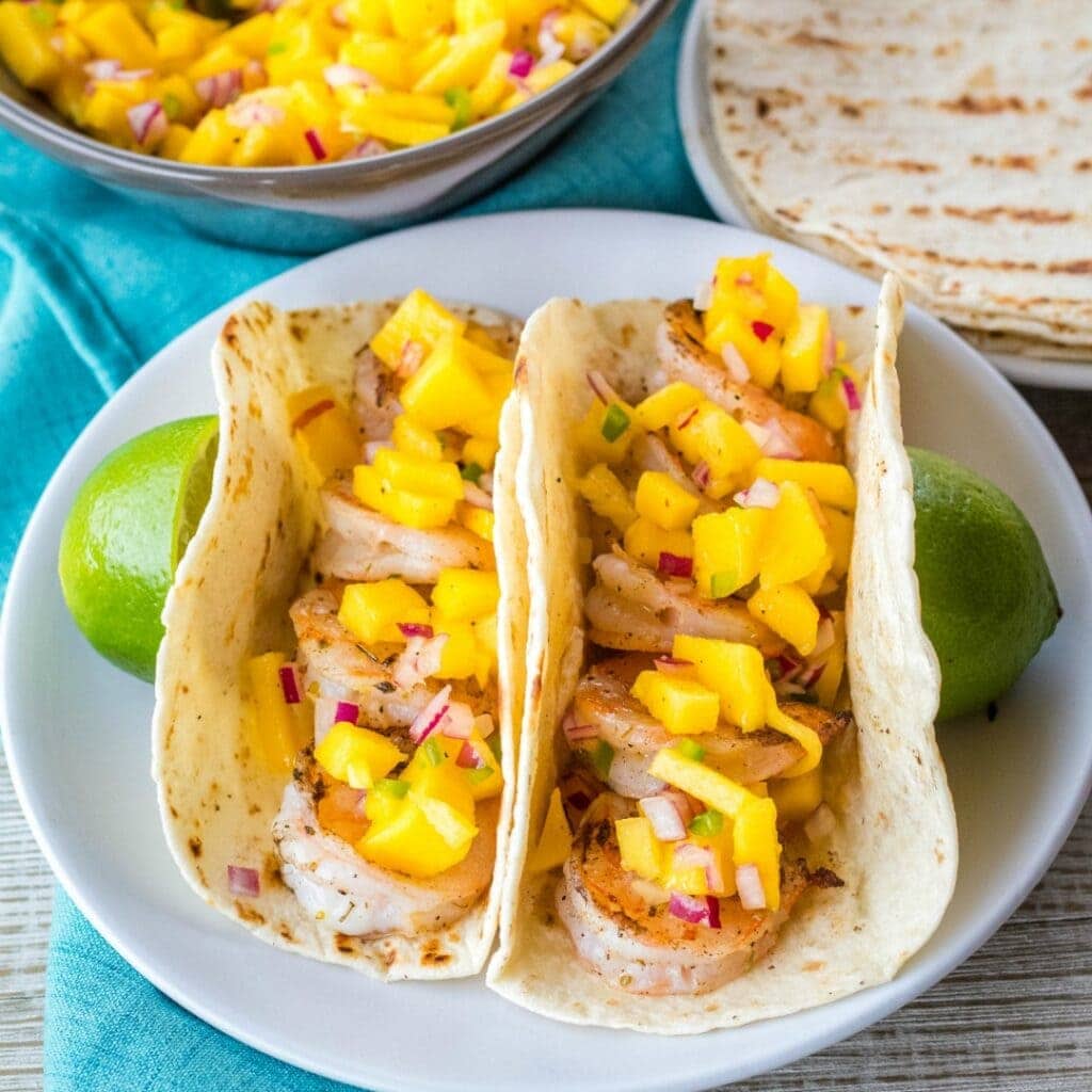 Grilled Shrimp Tacos are a 15-minute meal that's perfect for your next cookout! Colorful and delicious, they'll fly off the plate!