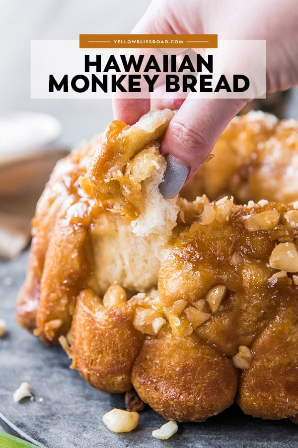 Hawaiian Monkey Bread with a hand taking a piece from it. Also with title text overlay.