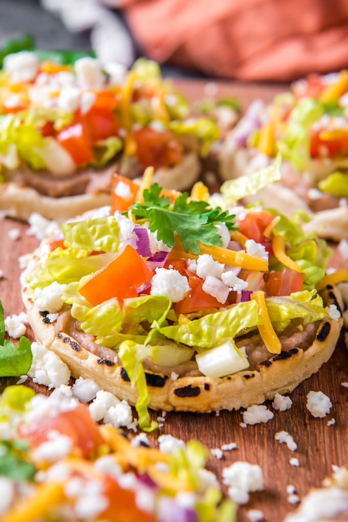 A close up picture of a mexican sope with toppings