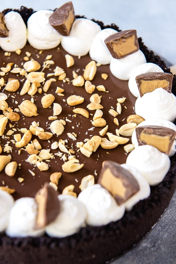 A side view of a peanut butter pie with chocolate crust.