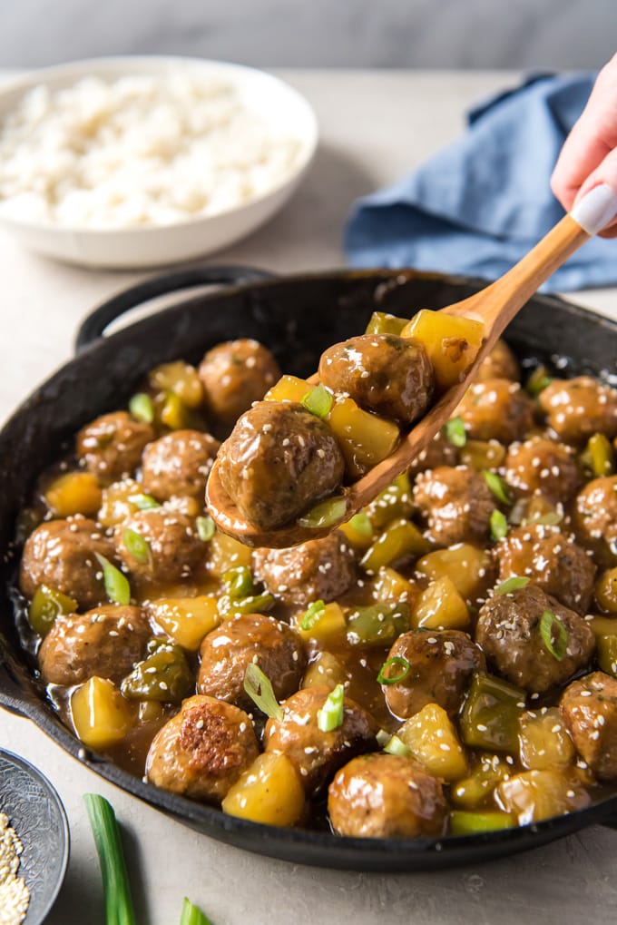 Sweet & Sour Meatballs with turkey meatballs, pineapple and bell peppers, all coated in a homemade sweet and tangy sauce. A great appetizer or main course. A pan full of turkey meatballs in a sweet and sour sauce with peppers and pineapple.