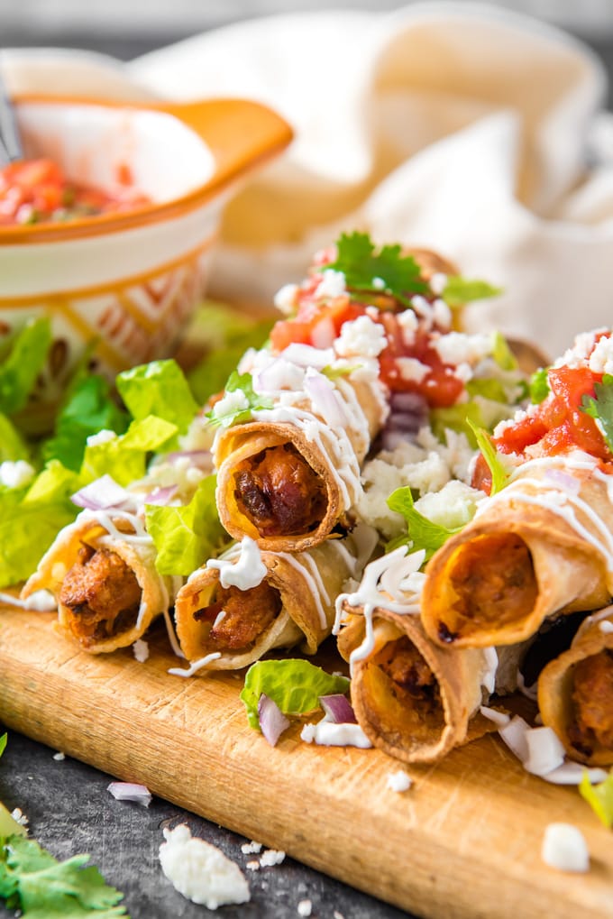 A stack of crispy fried taquitos